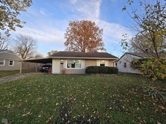 view of front of house with a front yard and a carport