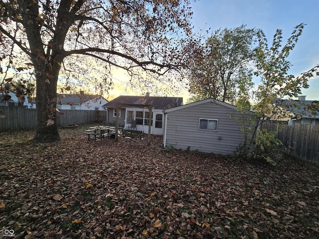 back house at dusk with a fire pit