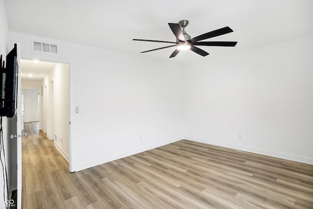 spare room featuring ceiling fan and light hardwood / wood-style floors