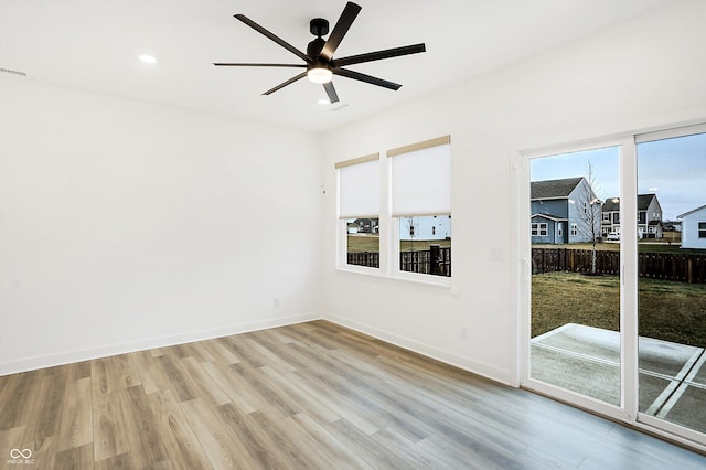 spare room with ceiling fan and light hardwood / wood-style floors