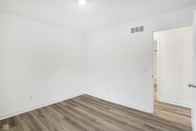 empty room with hardwood / wood-style floors