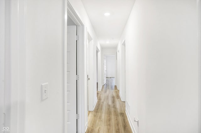 hallway with light hardwood / wood-style flooring