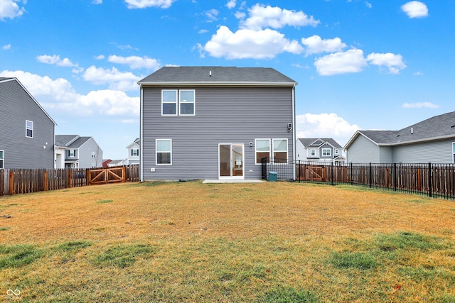 rear view of property with a lawn