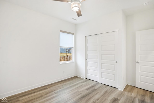 unfurnished bedroom with a closet, ceiling fan, and light hardwood / wood-style flooring