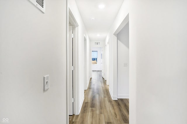 hall with hardwood / wood-style floors