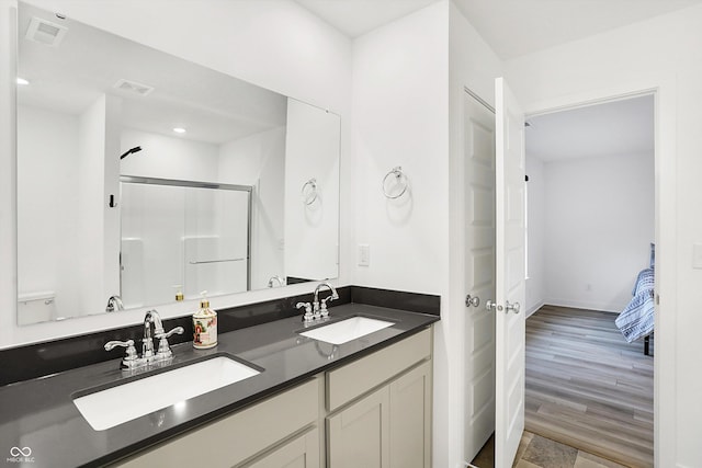 bathroom featuring toilet, wood-type flooring, walk in shower, and vanity