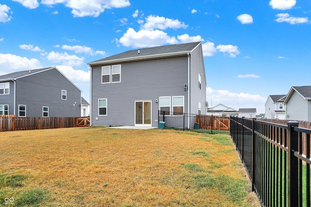 rear view of house featuring a lawn