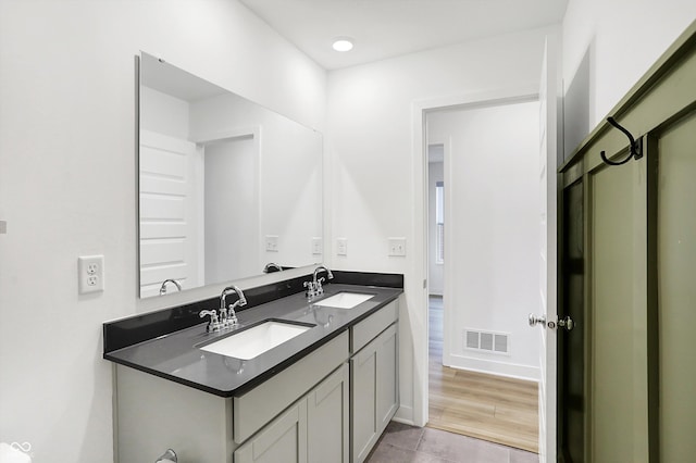 bathroom with tile patterned flooring and vanity