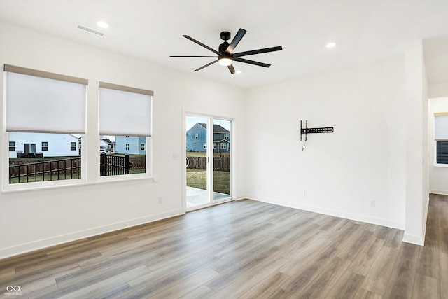 spare room featuring ceiling fan and light hardwood / wood-style flooring