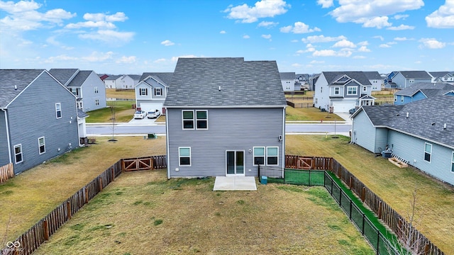 back of house featuring a patio area and a yard