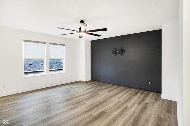 empty room featuring light wood-type flooring and ceiling fan