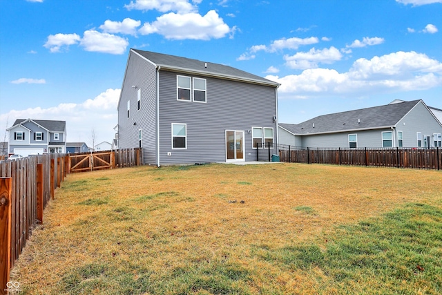 rear view of house with a lawn