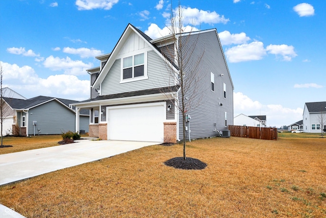 view of front of home featuring central air condition unit, a front lawn, and a garage