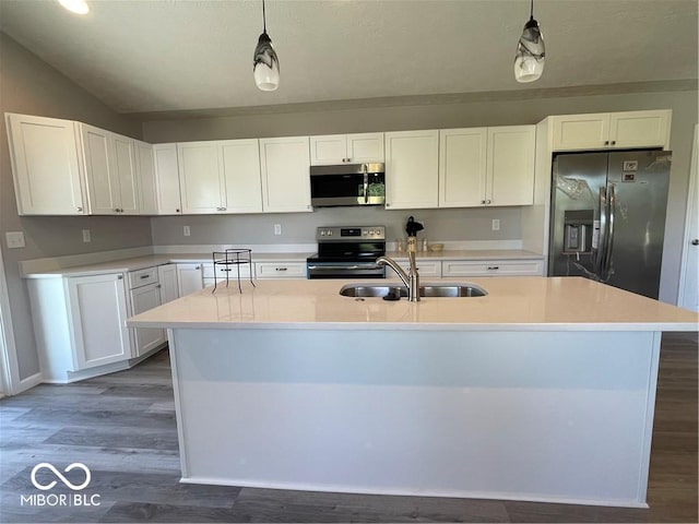 kitchen featuring decorative light fixtures, sink, white cabinetry, and stainless steel appliances