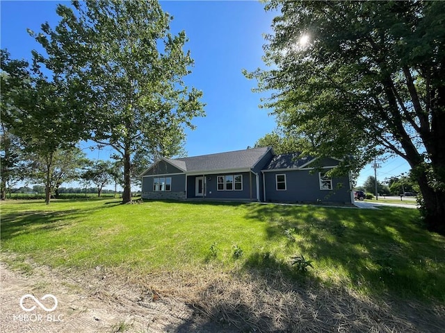 ranch-style home with a front lawn