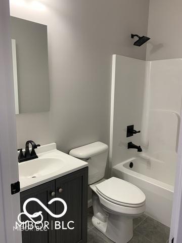 full bathroom featuring tile patterned floors, vanity, shower / bathing tub combination, and toilet