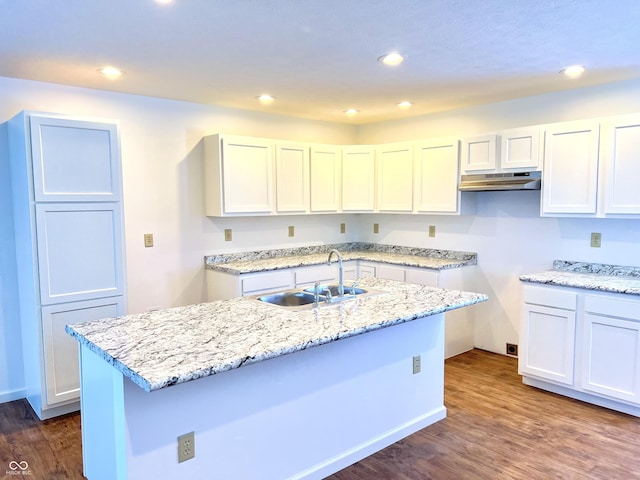 kitchen with sink, a center island with sink, white cabinets, and dark hardwood / wood-style flooring