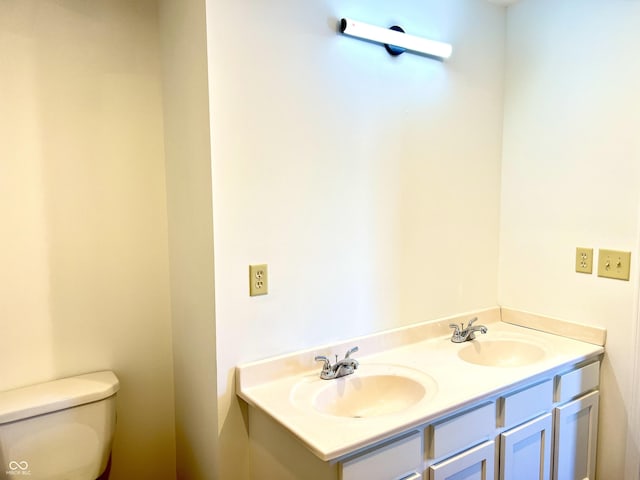 bathroom featuring toilet and vanity