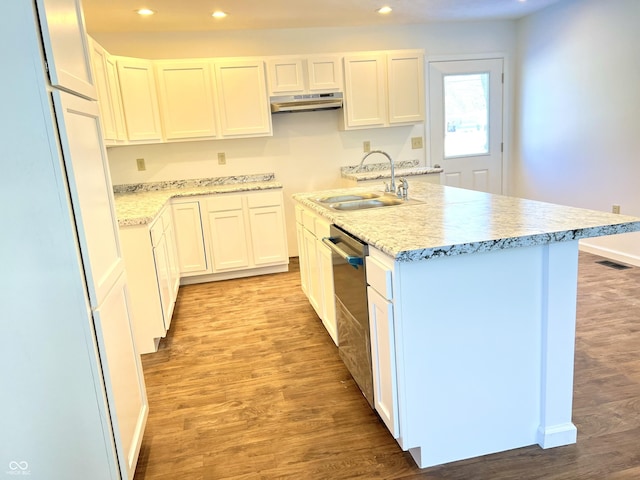 kitchen with sink, white cabinetry, stainless steel dishwasher, and an island with sink