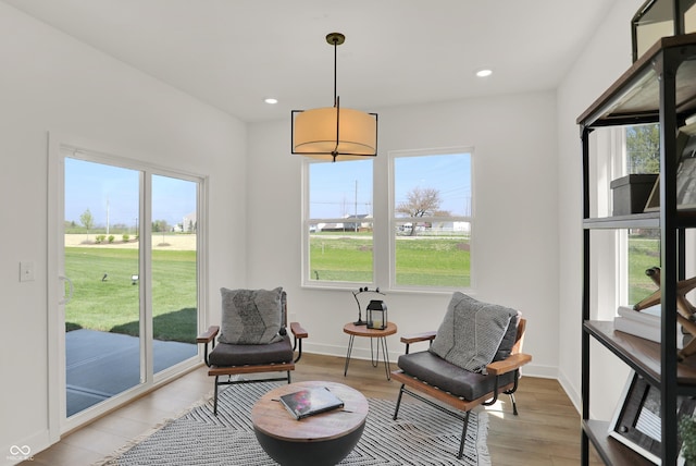 sitting room featuring light wood-style flooring, baseboards, and recessed lighting