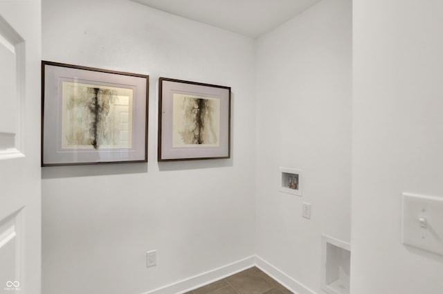 clothes washing area featuring hookup for a washing machine, laundry area, dark tile patterned floors, and baseboards