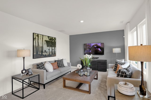 living area featuring recessed lighting and baseboards