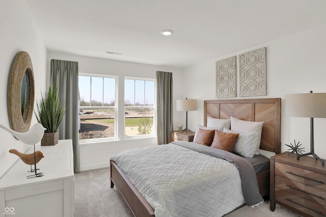 bedroom featuring light carpet, baseboards, and visible vents