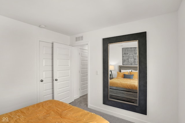 bedroom featuring carpet floors, a closet, and visible vents