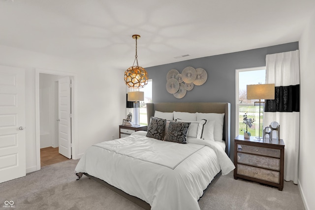 carpeted bedroom with baseboards and visible vents