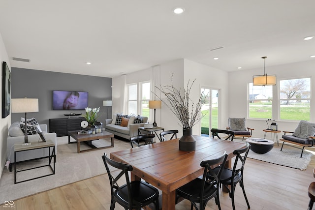 dining space with light wood-type flooring, visible vents, and recessed lighting