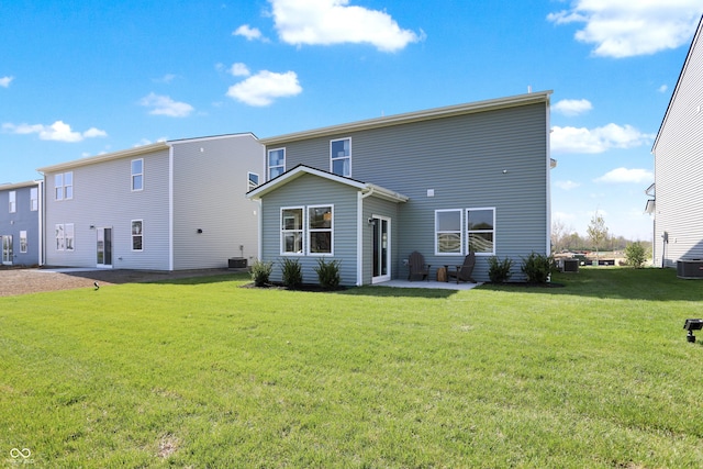 back of house with a patio area and a lawn