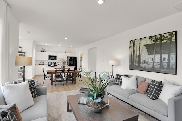 living area featuring light wood-style floors, visible vents, and recessed lighting