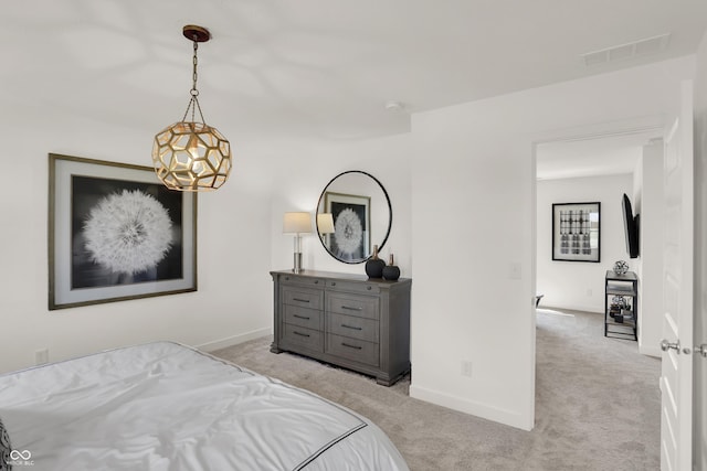 bedroom featuring baseboards, visible vents, and light colored carpet