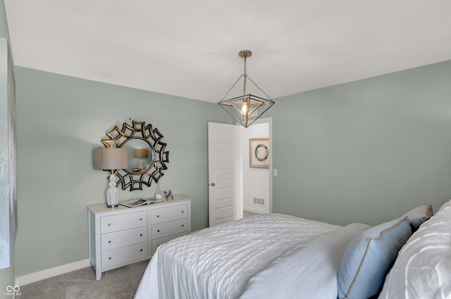 bedroom featuring baseboards, visible vents, and light colored carpet