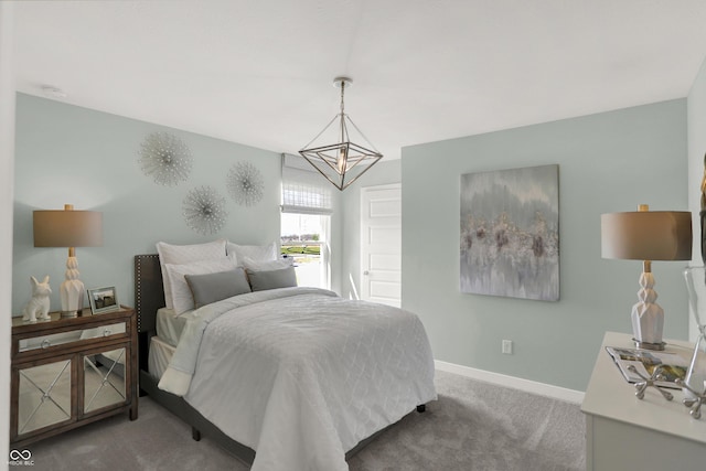 bedroom with baseboards, a chandelier, and carpet flooring