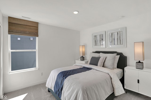 bedroom with carpet, visible vents, and baseboards