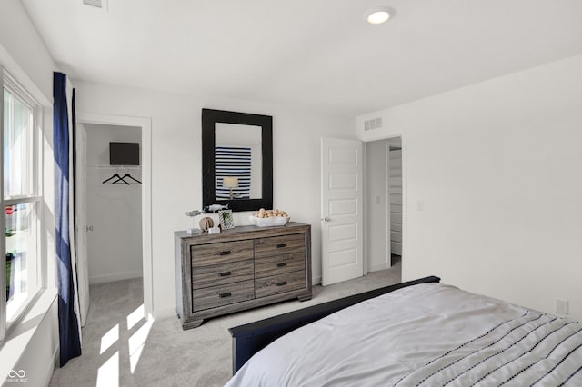 carpeted bedroom with baseboards, a spacious closet, visible vents, and a closet