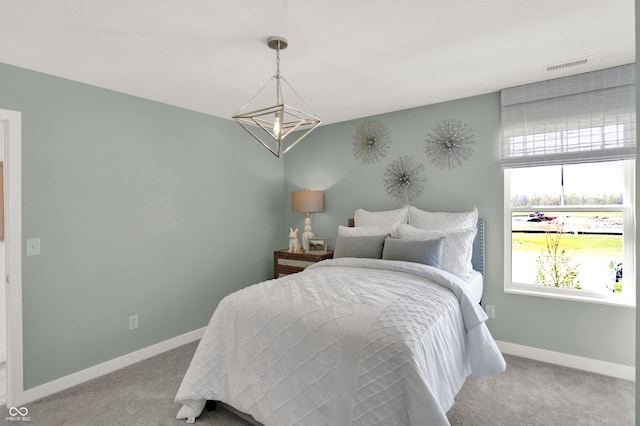 carpeted bedroom featuring visible vents and baseboards