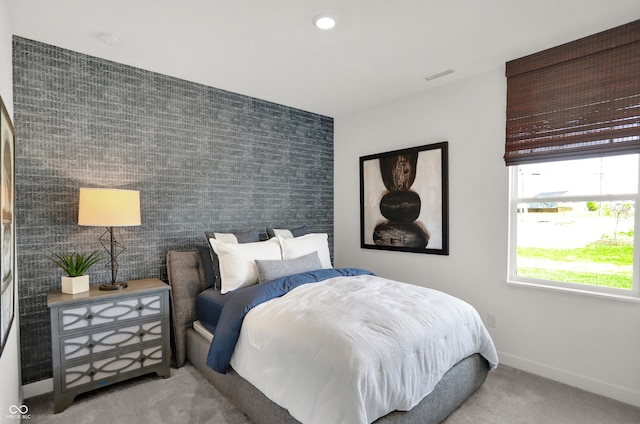 bedroom with recessed lighting, visible vents, an accent wall, baseboards, and wallpapered walls