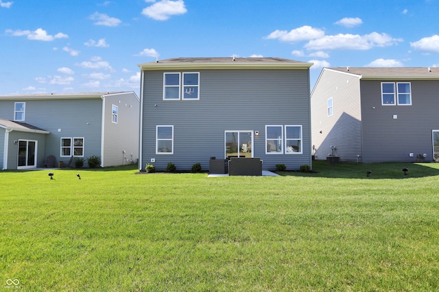 rear view of house featuring a lawn