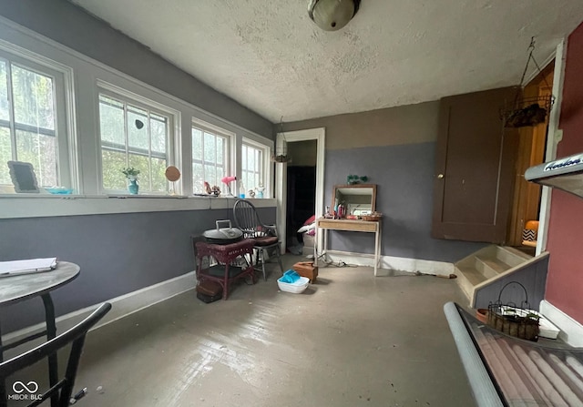 misc room featuring a textured ceiling and concrete floors