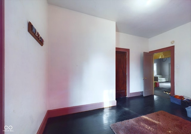 unfurnished room featuring dark hardwood / wood-style flooring