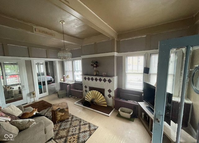 living room with a chandelier and a tile fireplace