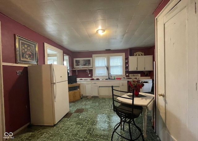 kitchen featuring white fridge and sink