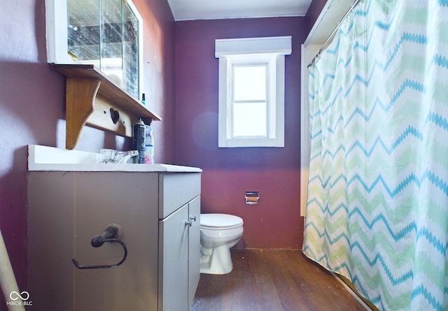 bathroom with toilet, vanity, a shower with shower curtain, and hardwood / wood-style floors