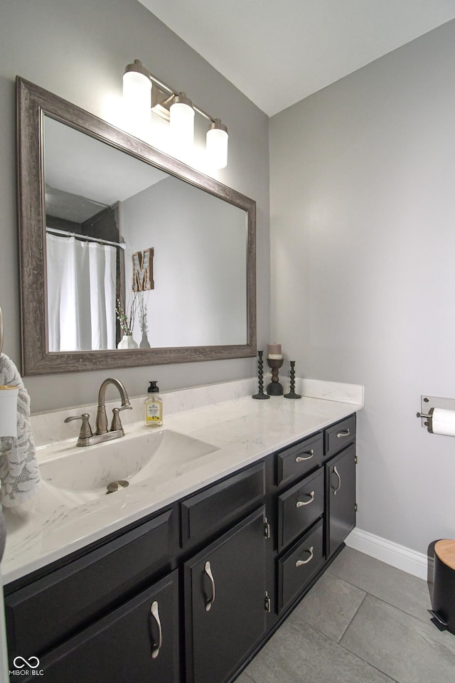 bathroom with tile patterned floors and vanity