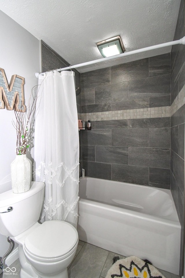 bathroom featuring tile patterned flooring, shower / bath combo, a textured ceiling, and toilet