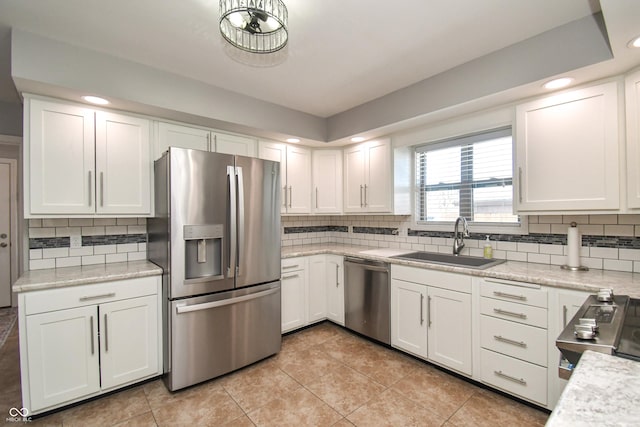 kitchen featuring stainless steel appliances, sink, and white cabinets