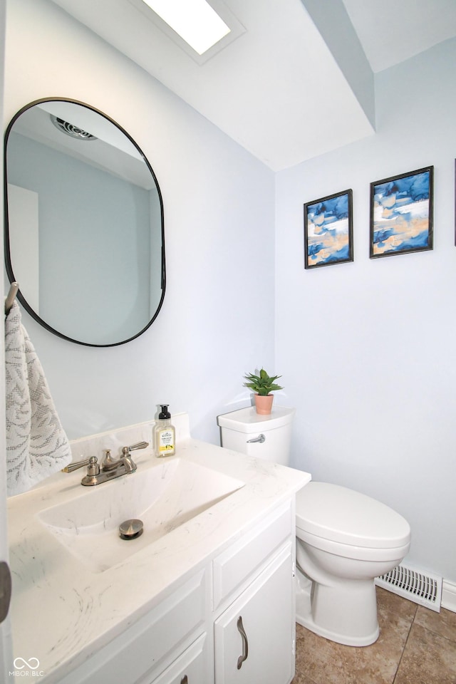 bathroom with vanity, tile patterned flooring, and toilet