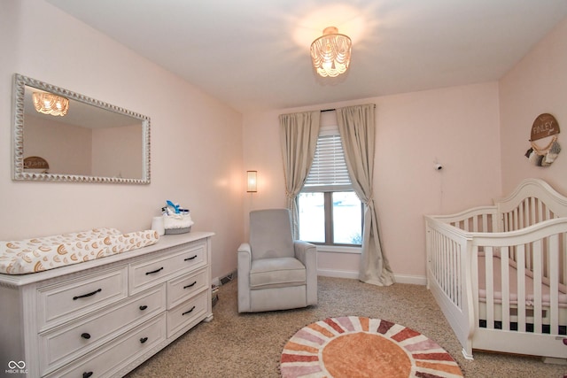 bedroom featuring a crib and light colored carpet